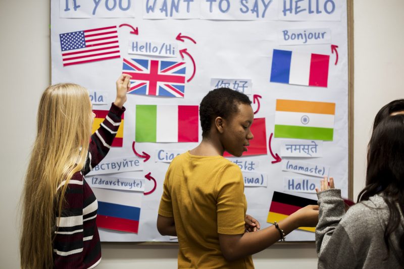 High school students working on international flags board